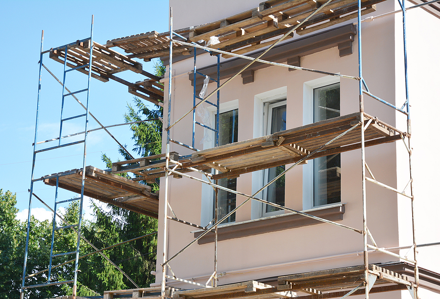 under construction house with scaffolding around it